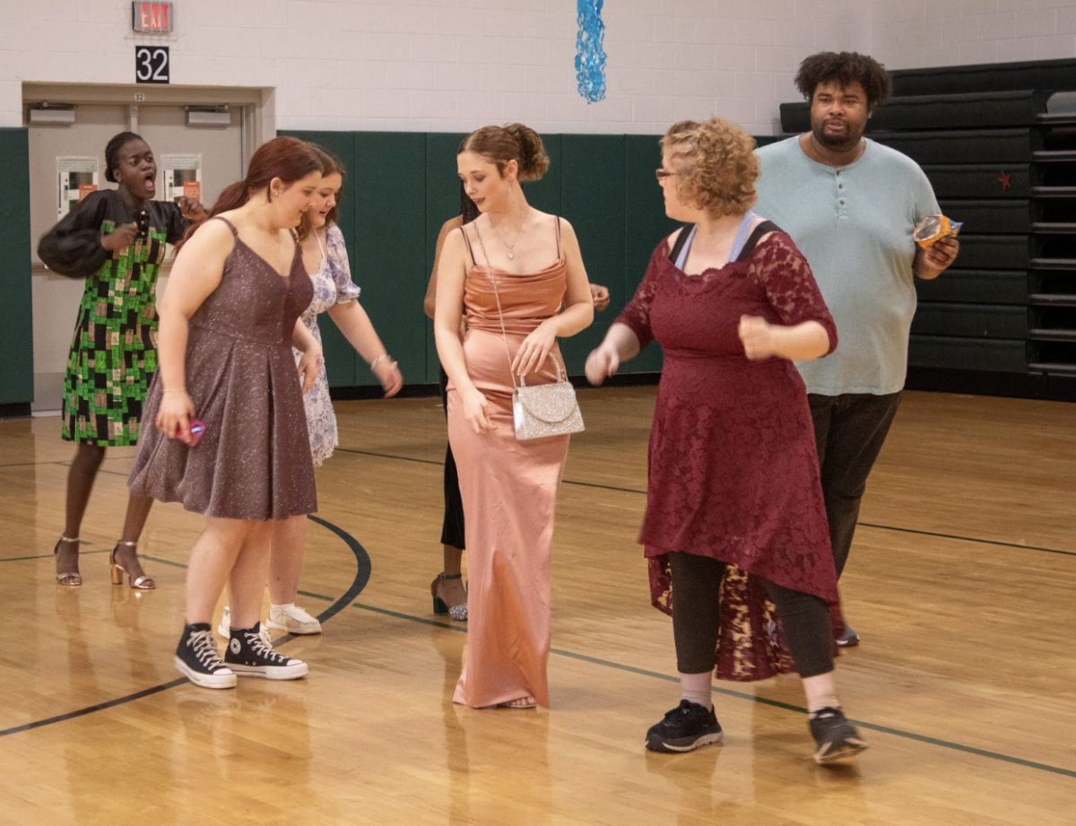 Buddy club members teach students different dance steps.